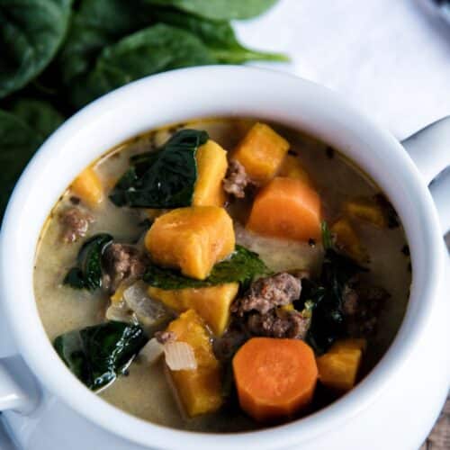 Sausage And Spinach Soup in a white pot.