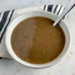 Paleo Turkey Gravy in a white plate with a spoon.