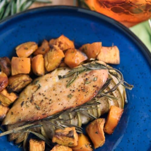 Apple-Stuffed Chicken With Sweet Potatoes Recipe on a blue plate