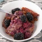 blackberry cobbler served in a white plate