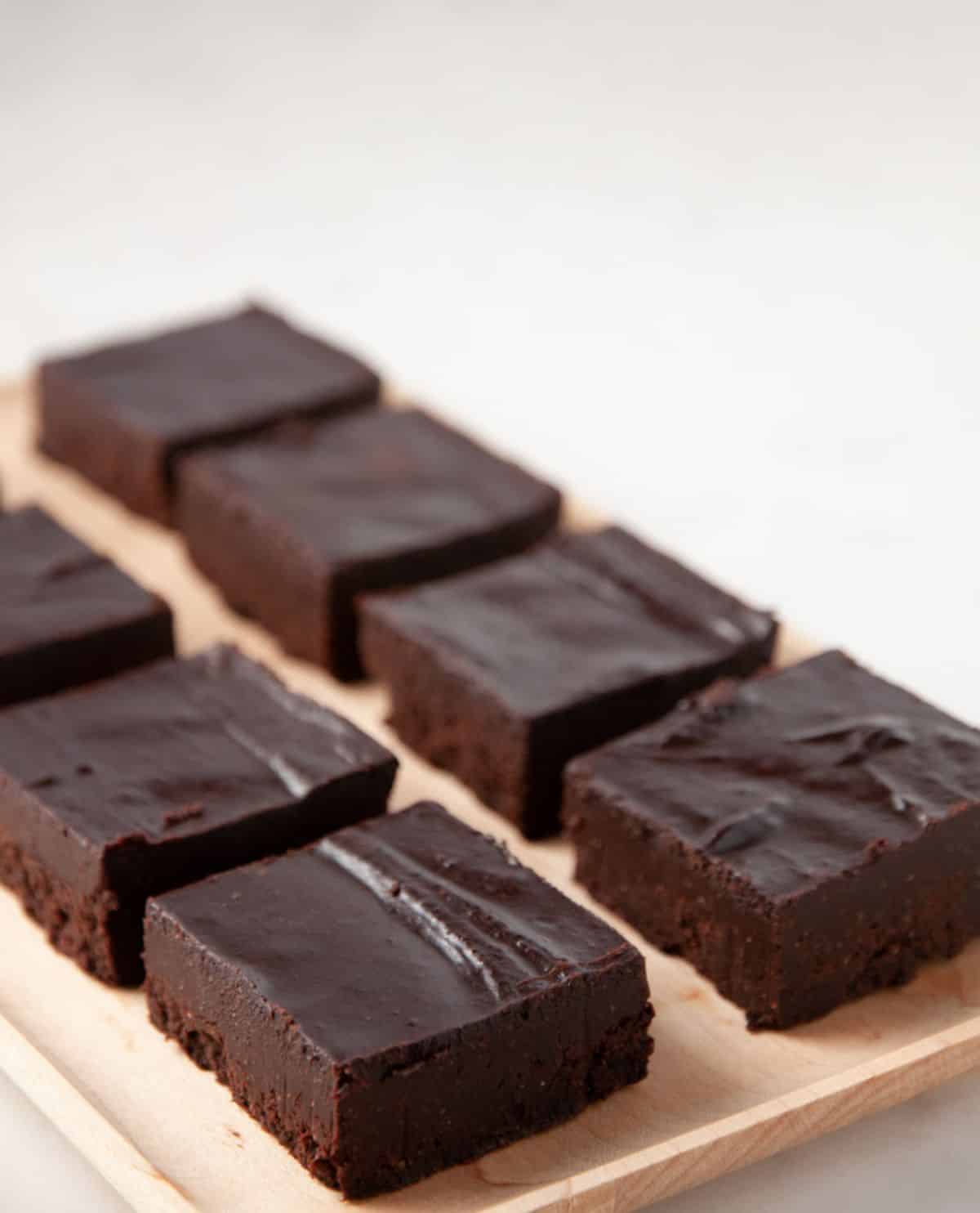 paleo chocolate fudge lined up on a cutting board
