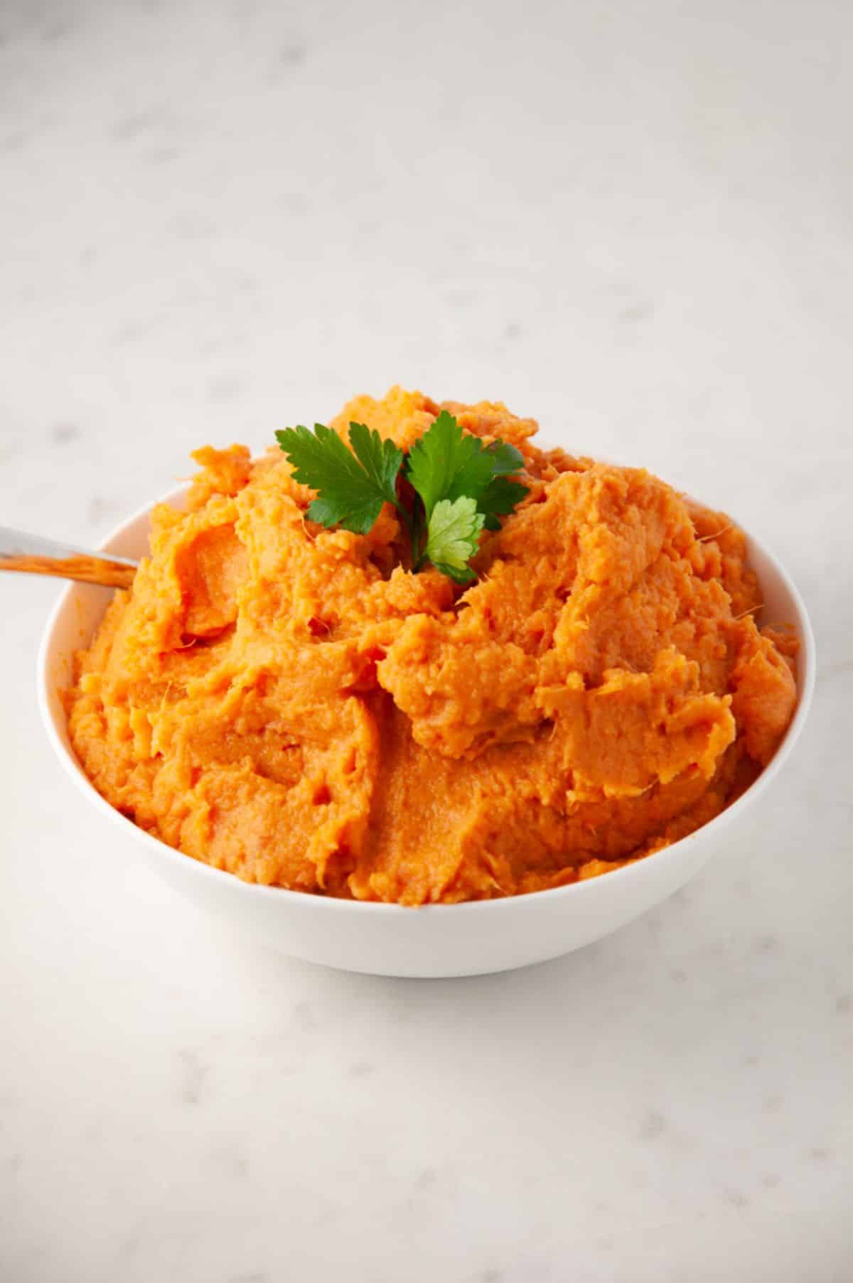 mashed sweet potatoes served in a white dish