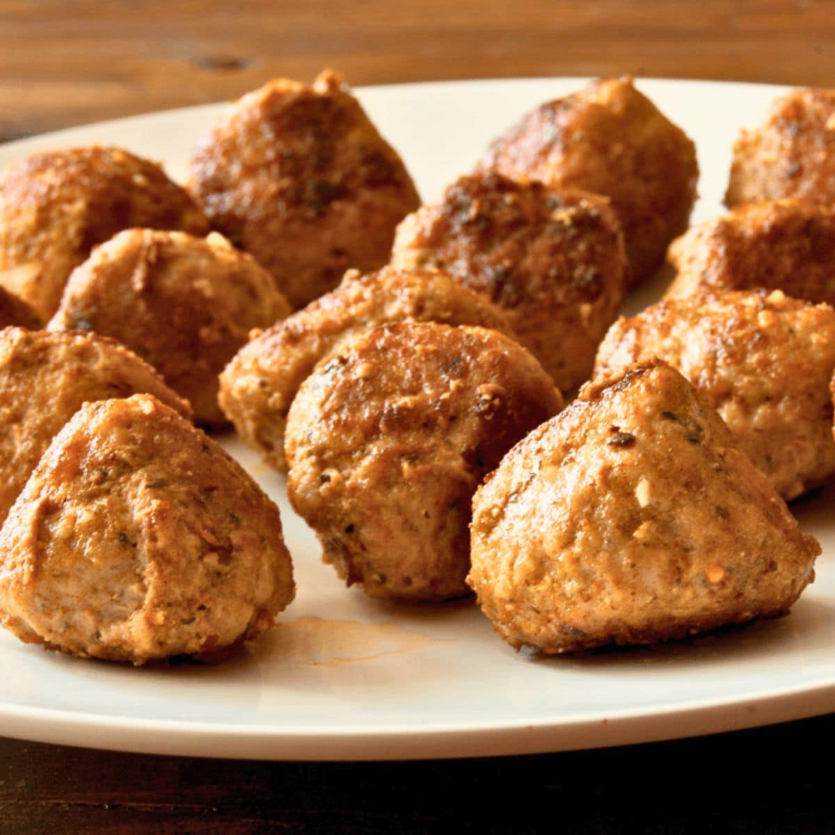 Herb meatballs on a white plate.