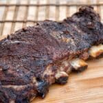 slab of baby back ribs on wooden cutting board