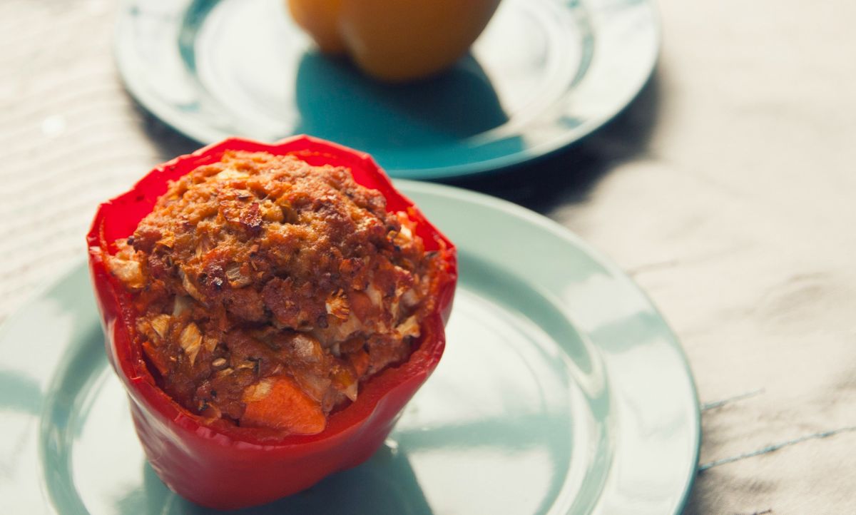 blue plate holding a single pork stuffed bell pepper 