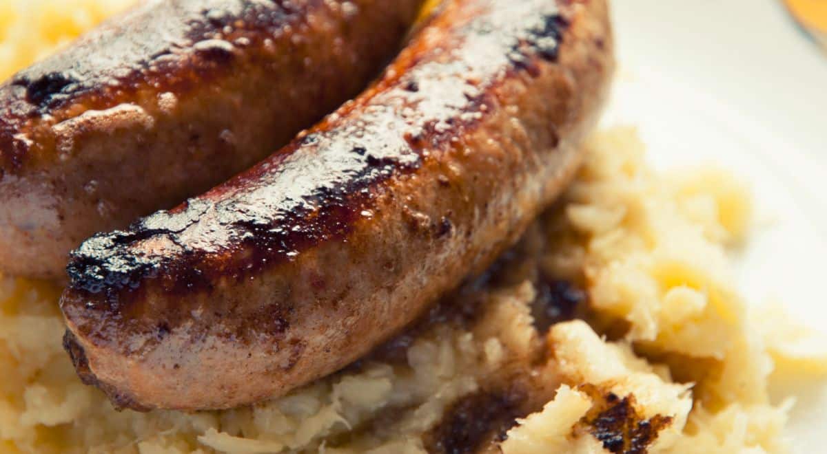 plate holding paleo sausage with parsnip mash