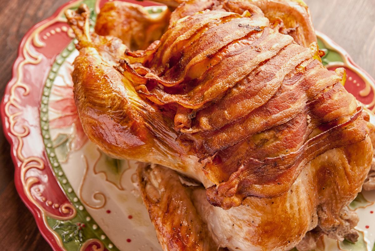 floral platter holding a whole bacon wrapped turkey