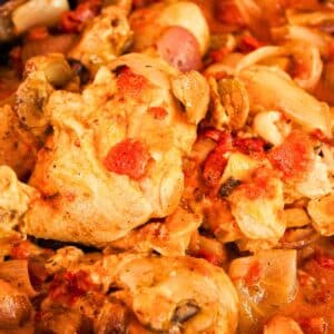 vibrant oranges and reds of mustard and tomato chicken stew, many vegetables