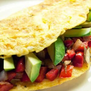 closeup of an Avocado omelet on a white plate