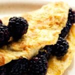 closeup of Blackberry and honey omelet on a white plate