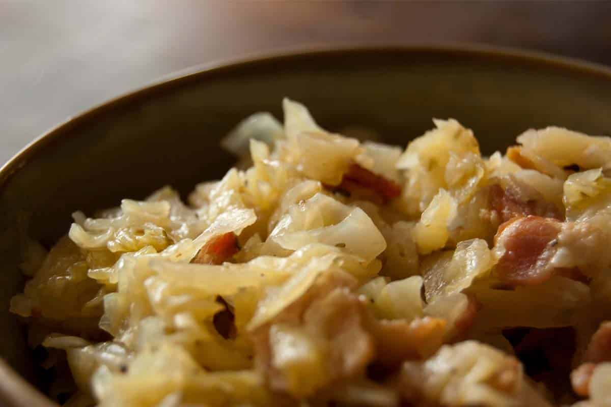 brown bowl filled with Braised Cabbage with Bacon