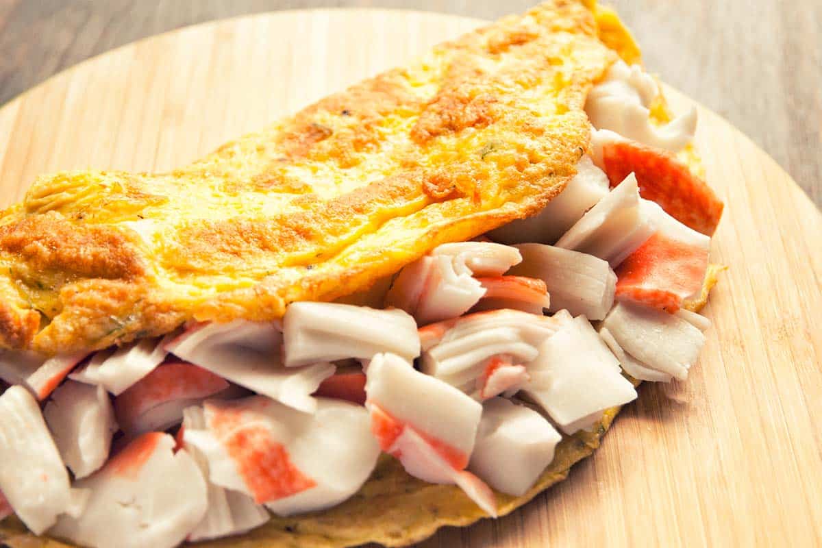 Lobster Omelet on a round wood cutting board