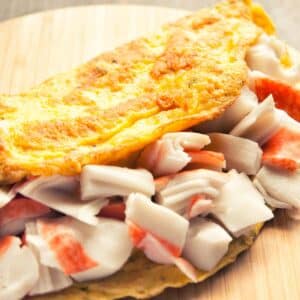 closeup of a Lobster Omelet on a wood round cutting board