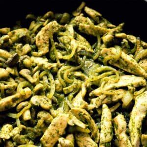 closeup of a pan of Minted pesto chicken stir-fried