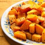 white plate full of Rosemary and Balsamic Vinegar Roasted Butternut Squash on a table