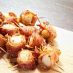 paleo-friendly bacon-wrapped scallops served on a white plate