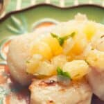 closeup of plate full of scallops with ginger pineapple salsa on top