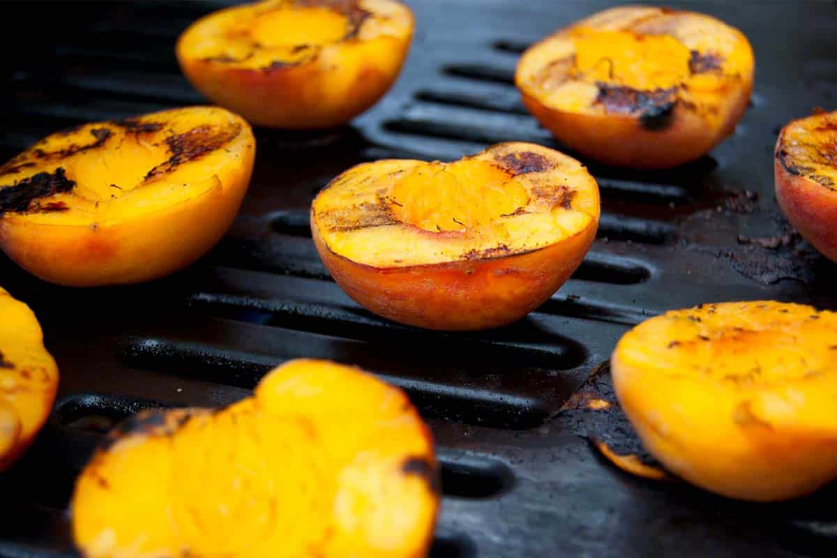 grill covered in BBQ grilled peaches with cinnamon