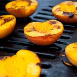 BBQ grilled peaches with cinnamon on a grill