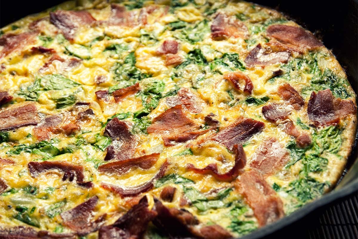 closeup of Bacon and Spinach Frittata in a pan