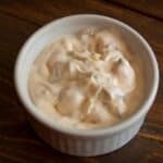 overhead view of a ramekin of Bacon & Mayonnaise Dip on a wood table