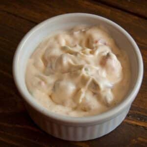 overhead view of a ramekin of Bacon & Mayonnaise Dip on a wood table