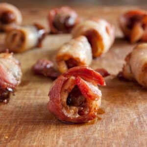 closeup of Bacon wrapped dates on a wood table