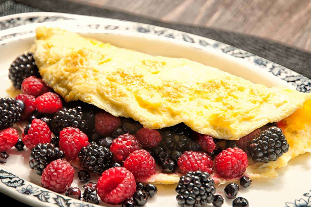 closeup of a Berry Omelet filled with blackberries, blueberries and raspberries