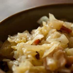closeup of a bowl of Braised Cabbage with Bacon on a table