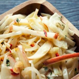closeup of a wooden bowl with Cabbage and apple stir-fry