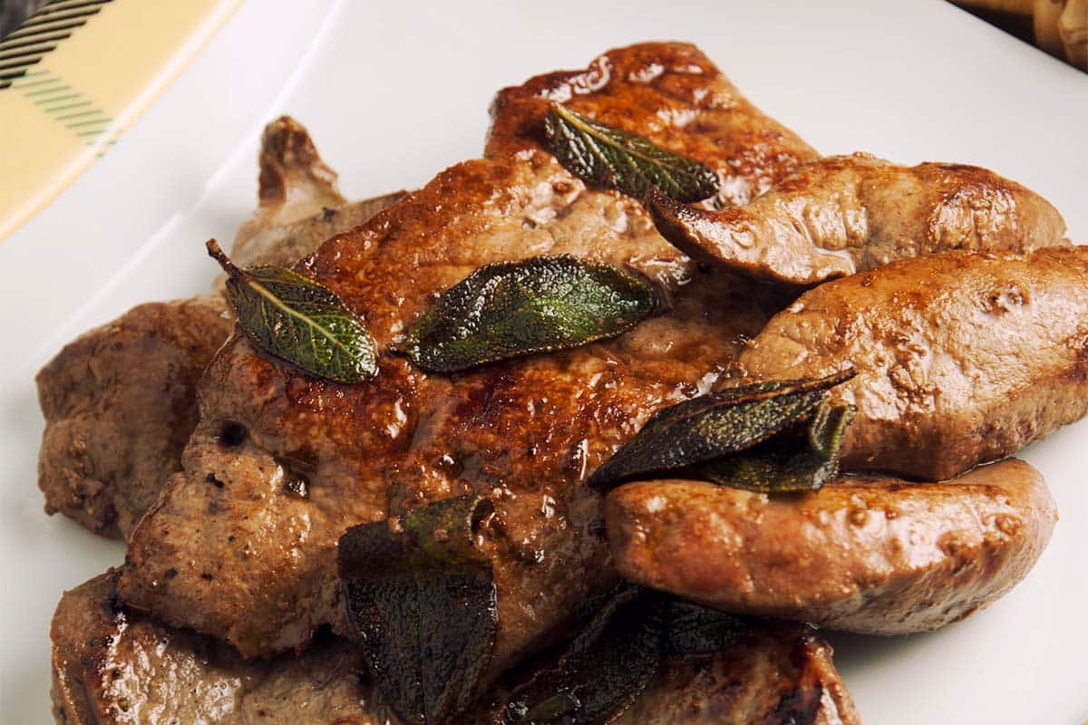 closeup of a white plate filled with Calf’s Liver with Lime and Sage