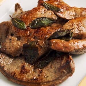 closeup of a serving of Calf’s Liver with Lime and Sage on a white plate