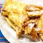 white plate filled with a Cinnamon and apple omelet