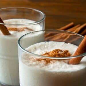 closeup of two glasses of cinnamon and Coconut vanilla milkshake