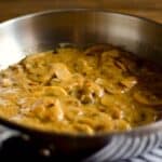 saucepan of Creamy Mushroom sauce on a wood table