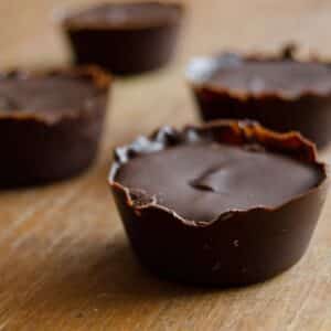 closeup of Dark Chocolate and Almond Butter Treats on a wood table