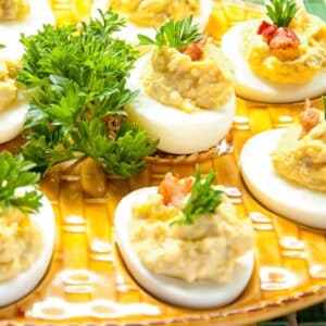 closeup of a yellow egg tray with Deviled eggs with bacon bits filling it