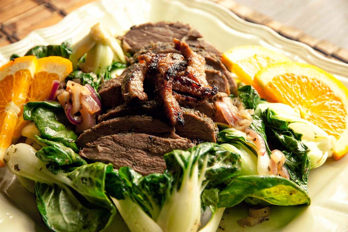 closeup of a plate filled with Duck and orange stir-fry