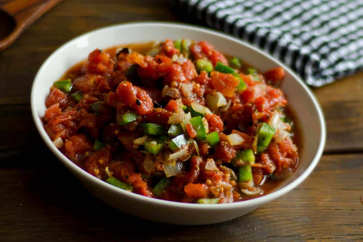 Garlic & Roasted Onion Salsa in a white bowl on a wood table