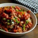 closeup of a white bowl filled with Garlic & Roasted Onion Salsa