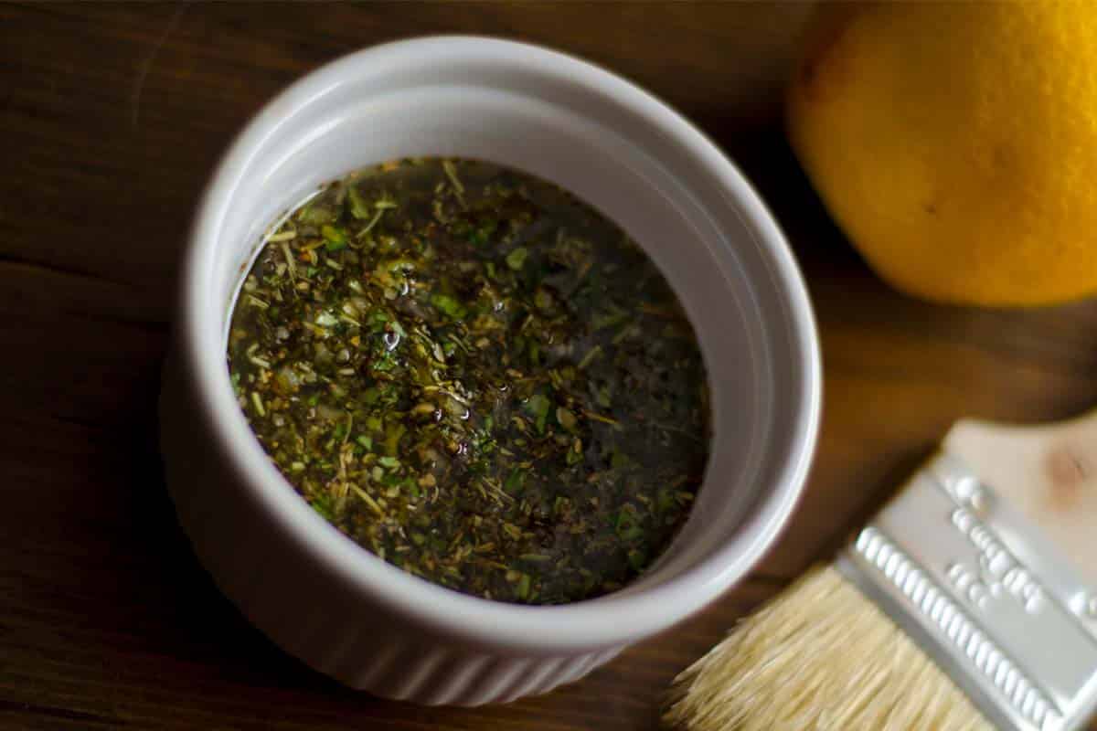 overhead view of a ramekin of Greek lamb marinade on a table