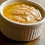 closeup of a white ramekin filled with Honey mustard vinaigrette