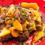 Lamb Liver with Oranges served on a red plate