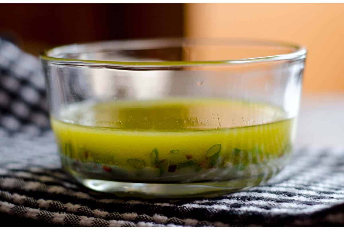 Lime and honey steak marinade in a glass bowl on a table