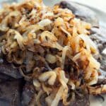 closeup of Liver and Onions on a white plate