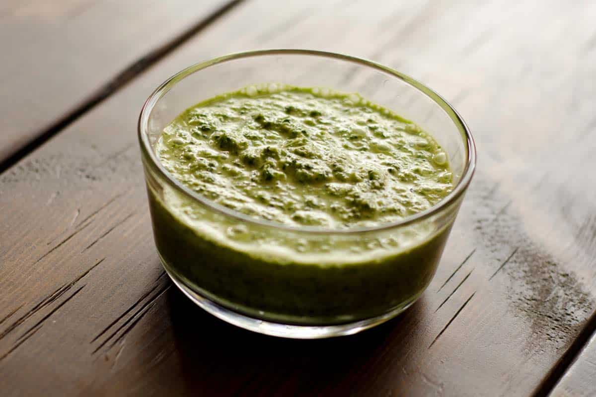 homemade mojo marinade in a glass bowl sitting on a wood table