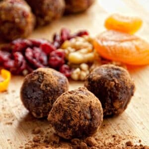 closeup of Nut and fruit balls on a wood cutting board