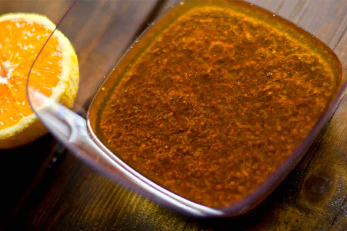 overhead view of a glass bowl of Orange chicken marinade