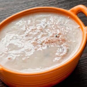 closeup of an orange casserole dish filled with Pork Liver and Heart Pâté