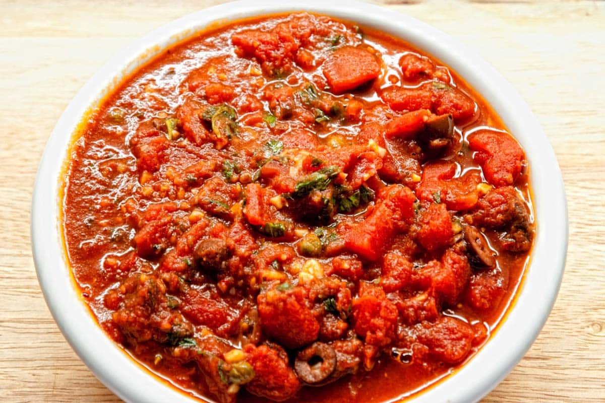 closeup of a large bowl filled with Putanesca sauce